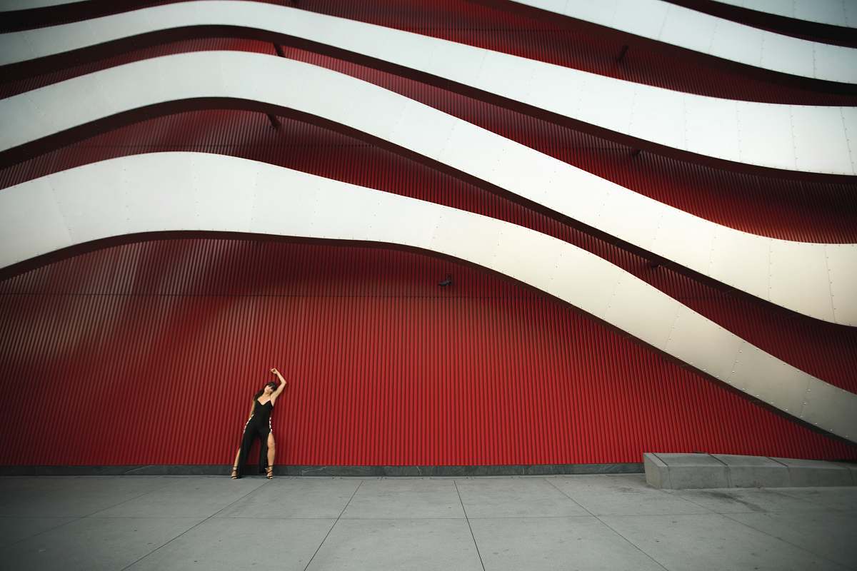 united states woman leaning on white and red wal stage